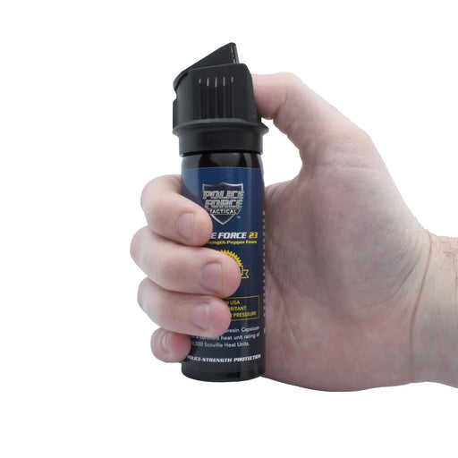 Hand holding a Police Force pepper foam canister