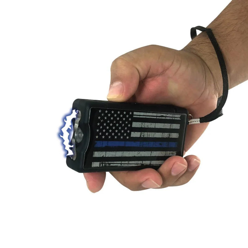 Police Force Blue Line stun gun held in hand with Triple Stun arc firing