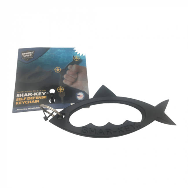 Black shark-shaped self-defense keychain with packaging on a white background