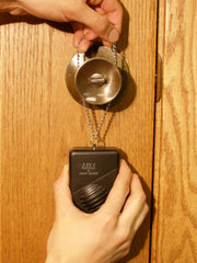 Sleepwalking door knob alarm hanging on bedroom door handle ready to detect sleepwalker exit attempt